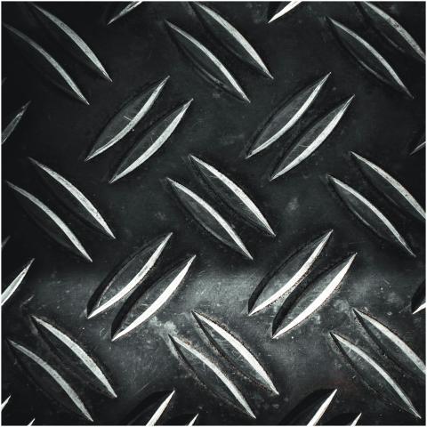 Close-up of a textured metal diamond plate with sy