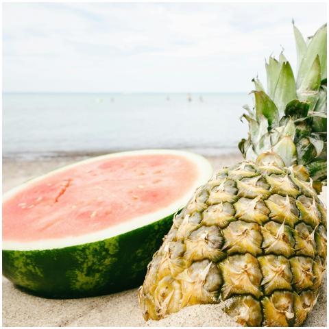 Close-up of juicy pineapple and watermelon on a sa