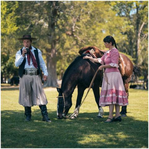 Argentine gaucho and woman in traditional dress wi