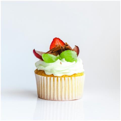 Close-up of a cupcake topped with strawberries, gr
