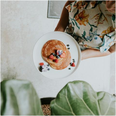 Overhead view of a woman holding a plate with panc