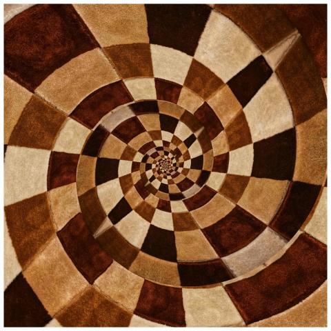 Intricate spiral design with earthy tones creating