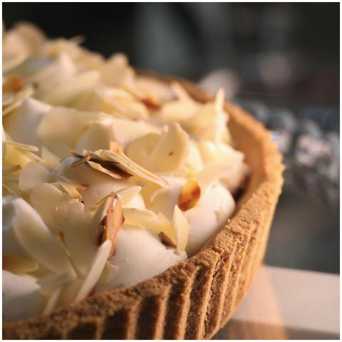Delicious cream tart topped with sliced almonds in