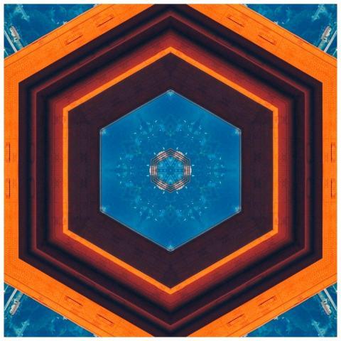Abstract hexagonal kaleidoscope pattern in blue an