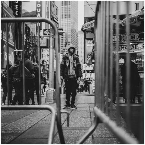 A black and white photo capturing people walking i