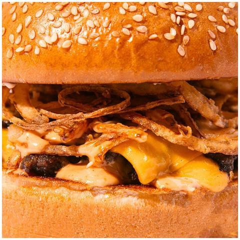 Mouthwatering close-up of a cheeseburger with cris