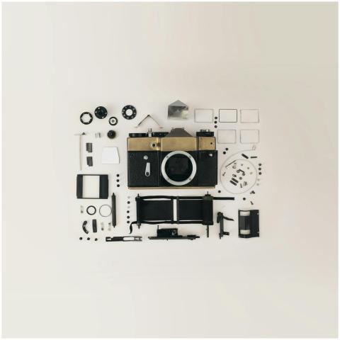 Flat lay of disassembled vintage camera parts show