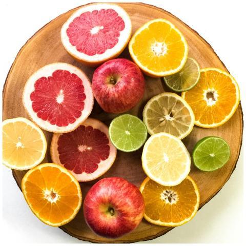 Vibrant display of sliced citrus fruits and apples