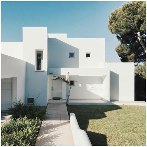 A minimalist modern white house exterior with clea