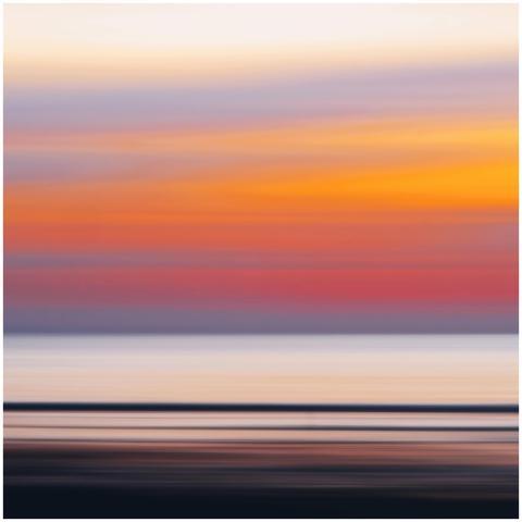 A dreamy, abstract depiction of a coastal sunset w