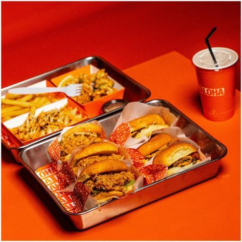 A vibrant display of burgers, fries, and a drink o