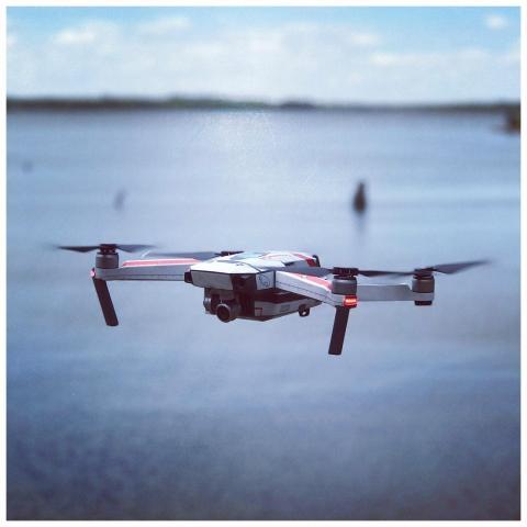 A drone flying over a calm ocean, capturing scenic