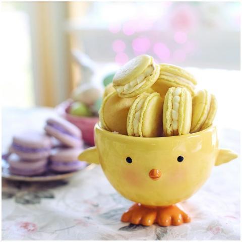 Charming yellow macarons in a festive chick bowl,