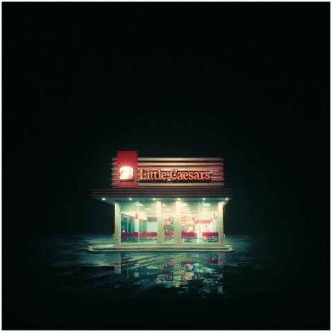 A brightly lit Little Caesars restaurant at night