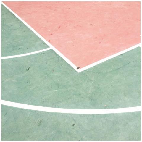 A vibrant pastel basketball court featuring green