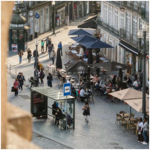 A lively street cafe in Porto with people enjoying