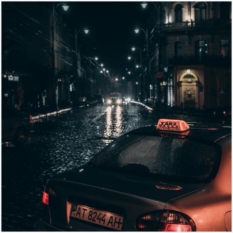 Dramatic city street scene with a taxi and rain-so
