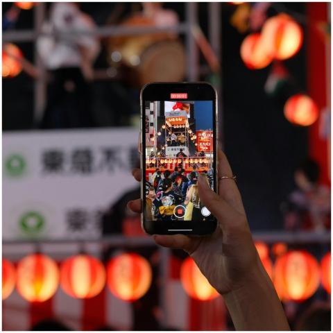 A smartphone captures the colorful festival vibes