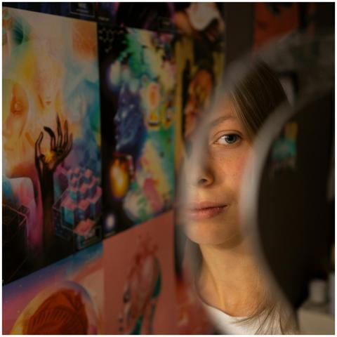 A woman's reflection in a mirror surrounded by vib