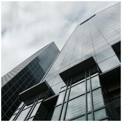 Low angle view of two modern skyscrapers with glas