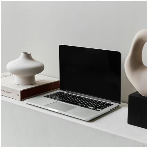 A sleek laptop on a modern desk alongside stylish