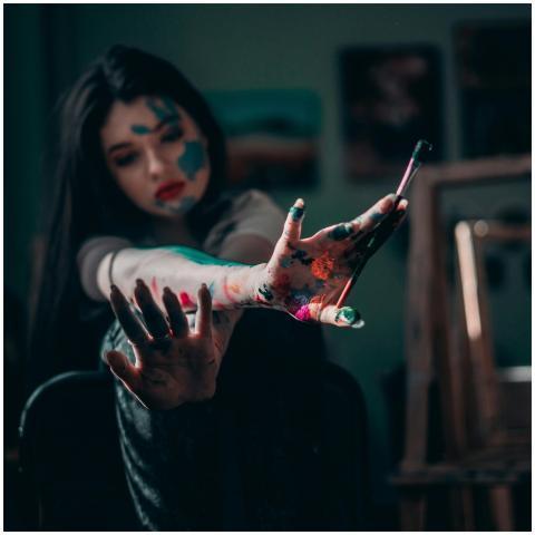 Young woman artist showing creativity with colorfu