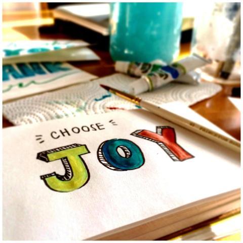 Colorful painting setup with 'Choose Joy' text, ev