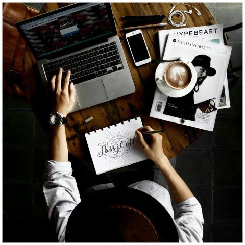 Top view of a creative workspace with laptop, coff