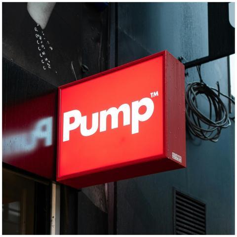 Vibrant red Pump sign on a storefront exterior in