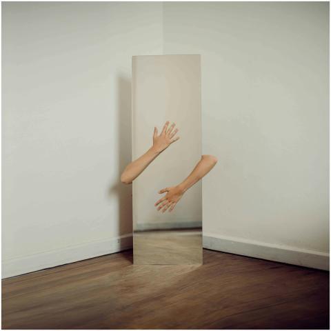 Surreal art photo with hands emerging from a mirro