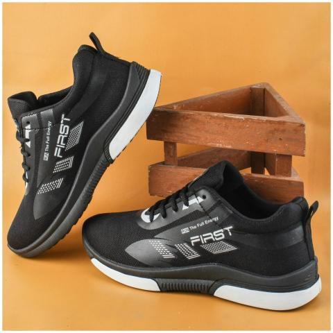 Stylish black sneakers showcased on an orange back