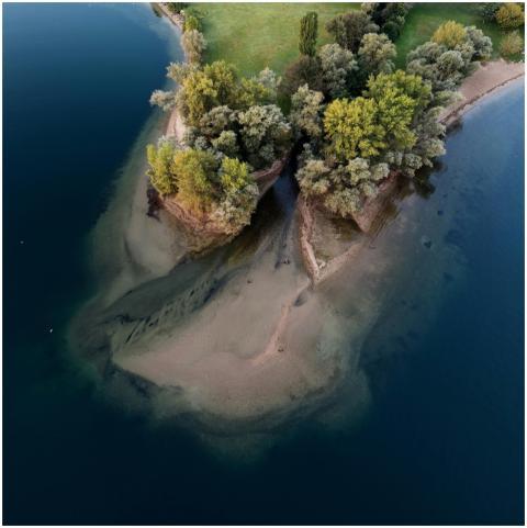 Stunning aerial view of a small, tree-covered isla