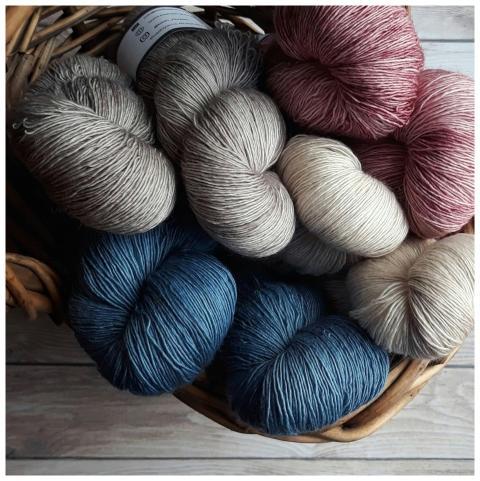 A collection of colorful yarn skeins in a basket,