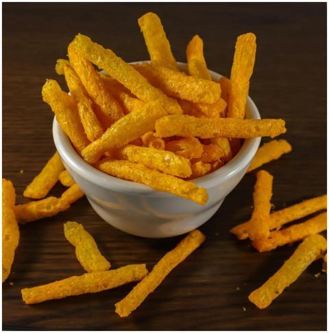 Close-up of crispy cheese sticks in a white bowl o