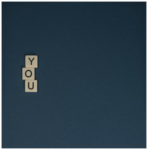 Scrabble tiles spelling 'YOU' with copyspace on a