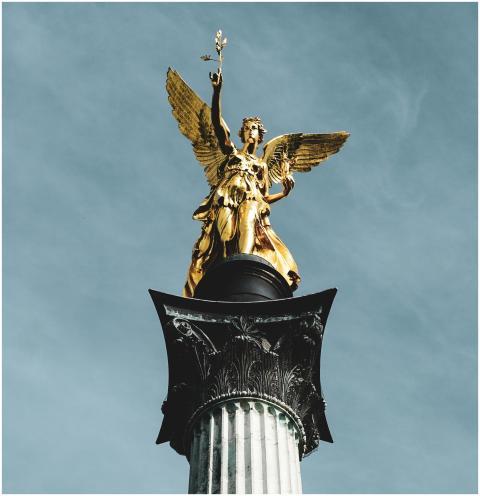 Golden angel sculpture atop Victory Column with a